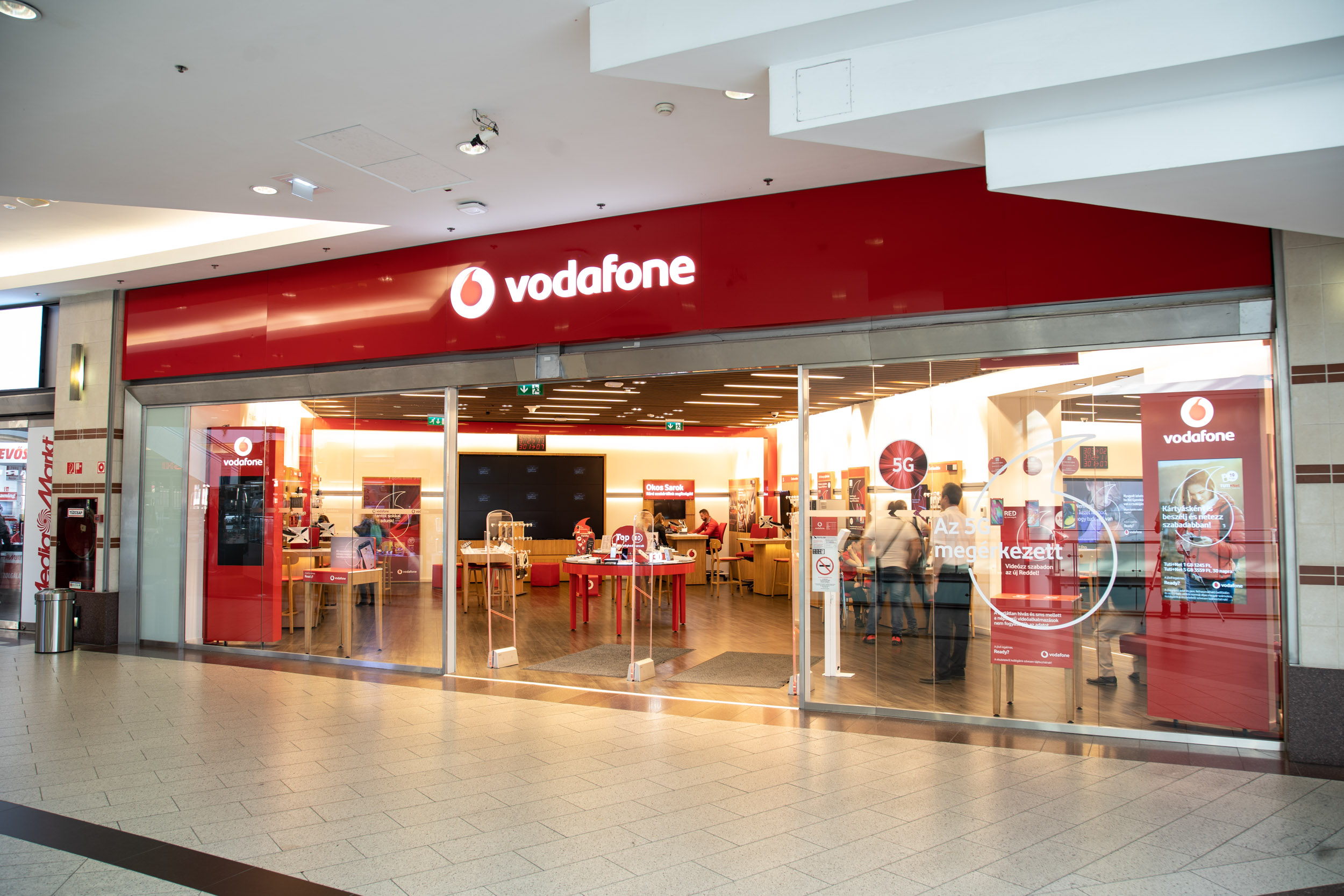 a Vodafone Mammut nyitvatartás az üzlet falán
